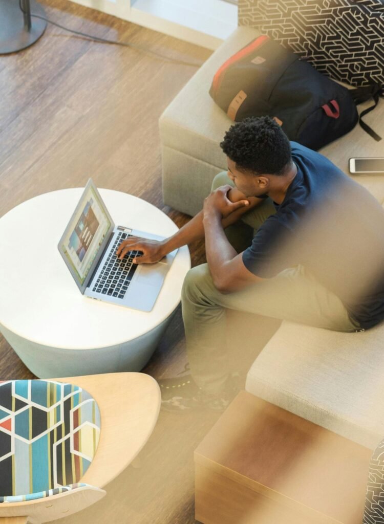 young individual sitting in front of the laptop